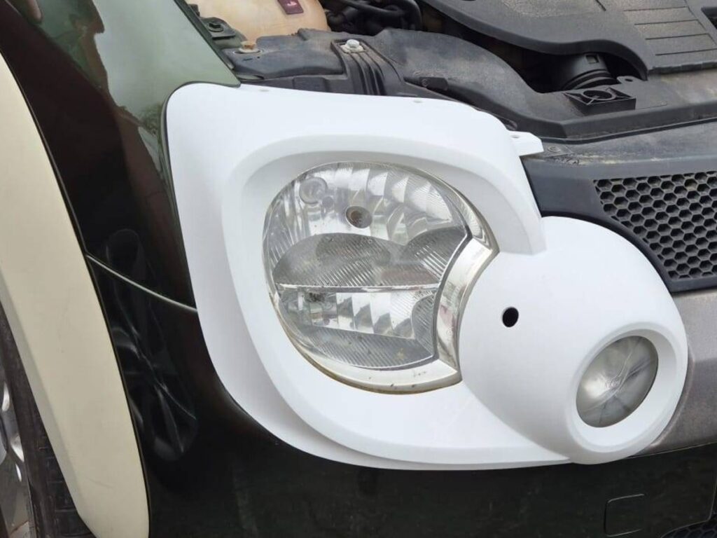 The reverse engineered 3D printed headlight housing fitted to the Fiat Panda before colour matching and paint